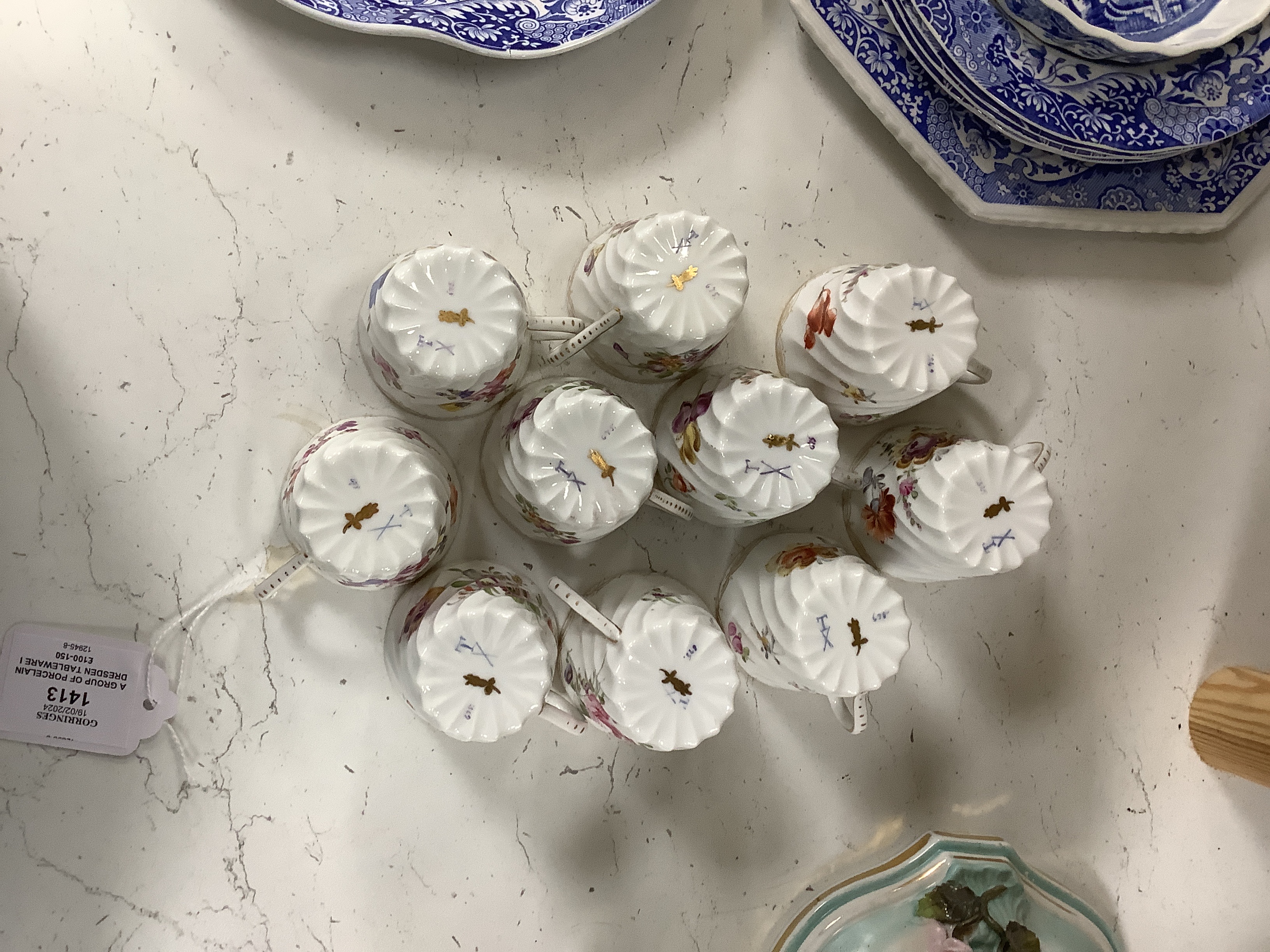 A group of porcelain Dresden tableware including cups and saucers and a blue and white jug